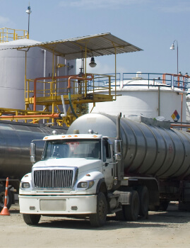 a tanker driving through an oil refinery