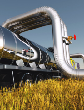 a fuel tanker under large pipes
